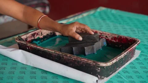 Close Shot of Hands Printing on Linen with Wooden Block in Workshop 動画素材 320930552