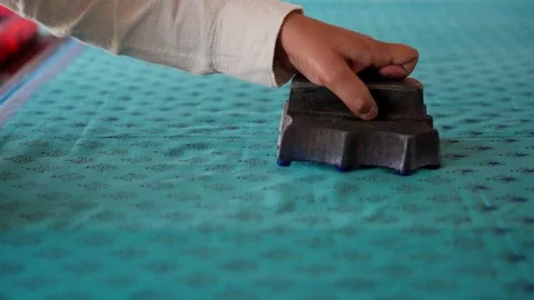 Close Shot of Hands Printing on Linen with Wooden Block in Workshop Stock Footage 320931025