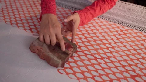 Close Shot of Hands Printing on Linen with Wooden Block in Workshop 動画素材 320931427