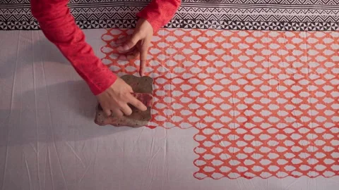 Close Shot of Hands Printing on Linen with Wooden Block in Workshop 動画素材 320931908