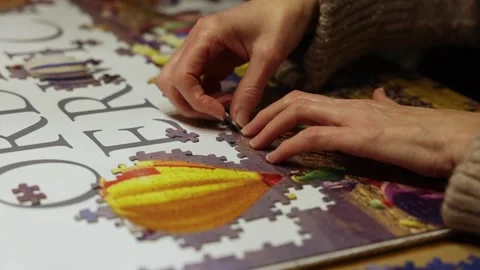 Close-up shot of hands putting jigsaw pieces into the correct position Stock Footage 294151821
