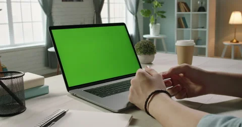 Close up shot of hands of remote worker gesturing near green screen laptop Stock Footage 132962874