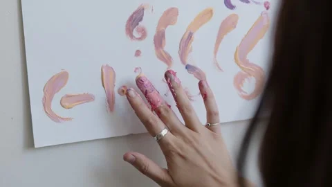 Close-up shot: hands stained with paint. A talented artist, a woman, draws a Stock Footage 247128787