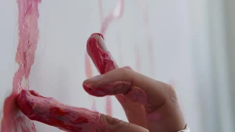 Close-up shot: hands stained with paint. A talented artist, a woman, draws a Stock Footage 247128804