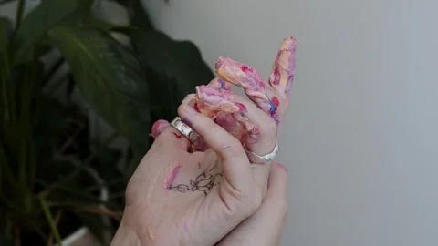 Close-up shot: hands stained with paint. A talented artist, a woman, draws a Stock Footage 247128814
