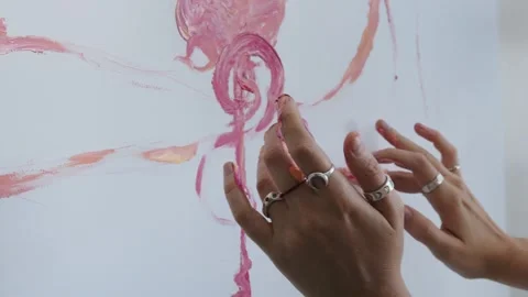 Close-up shot: hands stained with paint. A talented artist, a woman, draws a Stock Footage 247128972