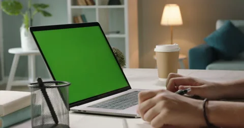 Close up shot of hands of student working with chroma key green screen laptop Stock Footage 136575274