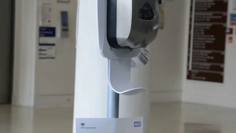 Close shot, hands taking gel sanitizer from dispenser Stock Footage 126299279
