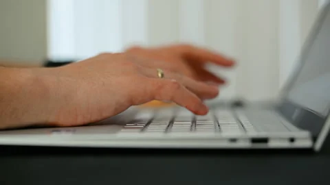 Close up shot of hands typing on a computer keyboard in an office environment, Stock Footage 335948450