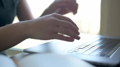 A close-up shot of hands typing on a laptop keyboard, capturing the focused Video stock 280952434