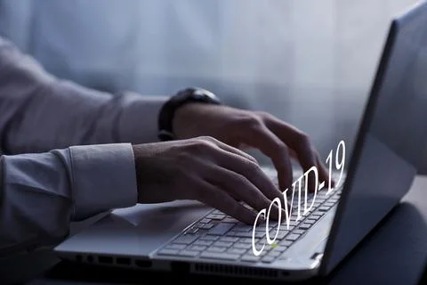 Close up shot of hands typing on a laptop at the night at home.Covid-19 Stock Photos
