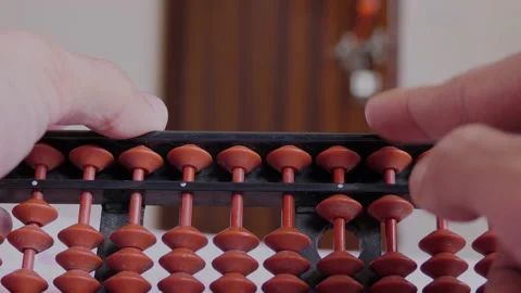 Close shot of hands using abacus and calculating Stock Footage 148567938