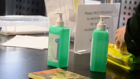 Close shot of hands using cleaning wipes, University of London Stock Footage 126299213