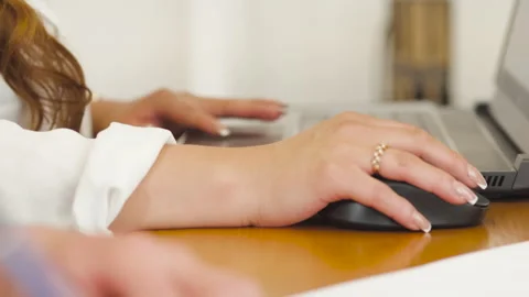 Close-up shot of hands using a computer mouse and keyboard Stock Footage 342227560