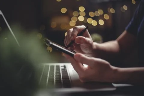 Close up shot of hands using smart pen typing on smart phone for searching wi Stock Photos