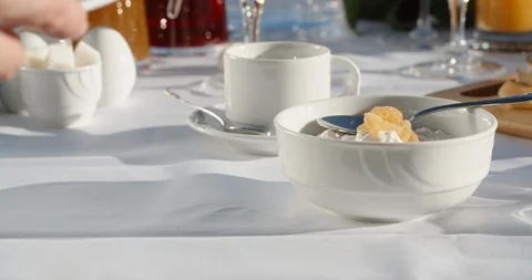 Close up shot of hands of a waiter preparing dishes for client's breakfast at Stock Footage 124463537