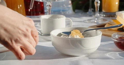 Close up shot of hands of a waiter preparing dishes for client's breakfast at Stock-Footage 125736572