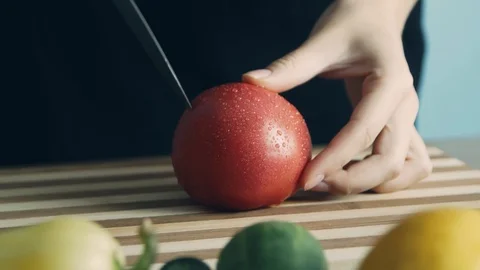 Close up shot hands of women using kitchen knife slide cut fresh tomato on wo Stock-Footage 112741309
