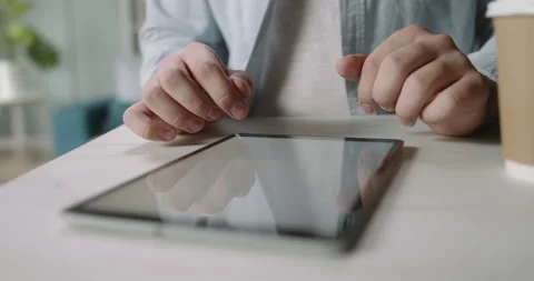 Close up shot of hands working on tablet computer, browsing web pages. Student Stock-Footage 138644592