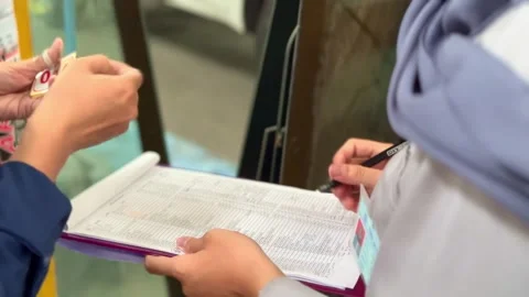 Close-up shot of hands writing and checking documents. Stock Footage 320938913