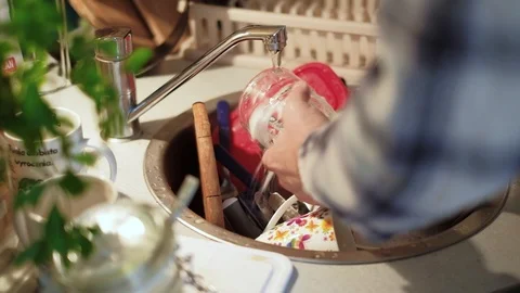 Close up shot of hands of  a young man washing dishes Stock Footage 95401498