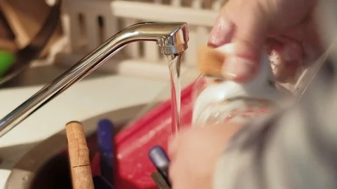 Close up shot of hands of  a young man washing dishe Stock Footage 95401509