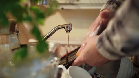 Close up shot of hands of  a young man washing dishes Stock Footage 95412404