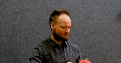 Close shot of Handsome beard man music teacher playing the guiro Stock Footage 106082016