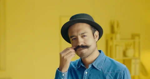 Close up shot of handsome Hispanic young man twirling mustache and looking at Stock Footage 171446629