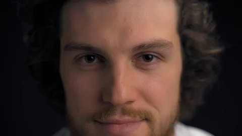 Close shot of a handsome young man isolated on black. Stock Footage 127803959