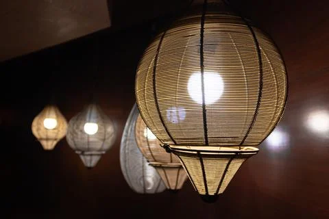 From close up shot of hanging ceiling lights with others. Stock Photos