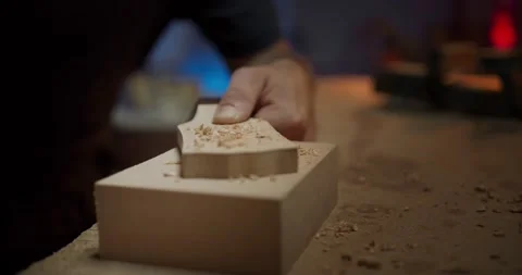 Close up shot of happy professional carpenter luthier blowing out wood sand from Stock Footage 137243742
