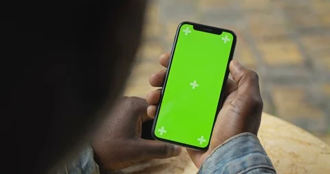 Close Up Shot of Head and Hand of Afro American Man Holding his Smartphone with Video stock 119410795