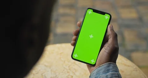 Close Up Shot of Head and Hand of Afro American Man Holding his Smartphone with Video stock 119418482