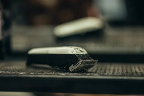 Close shot of a hear trimmer full of hair in a barbershop Stock Photos