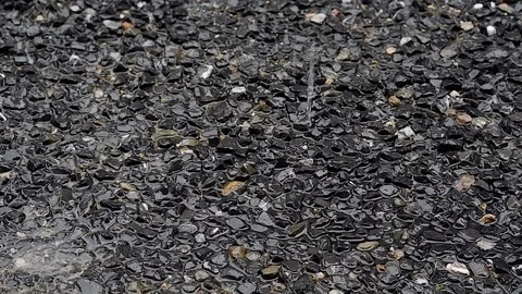 Close up shot of heavy rain drop on black gravel stone floor and road in country Vídeos de archivo 89197757