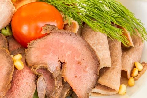 Close-up shot highlighting an exquisite cold meat platter with sliced roast b Stock Photos