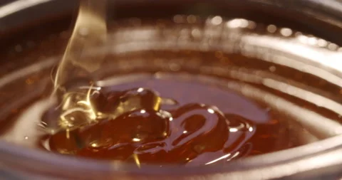 Close up shot of honey jar getting filled with honey Video stock 135347320
