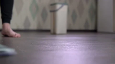 Close-up shot, hostess takes a mop for and wipes the floor Stock Footage 153905607