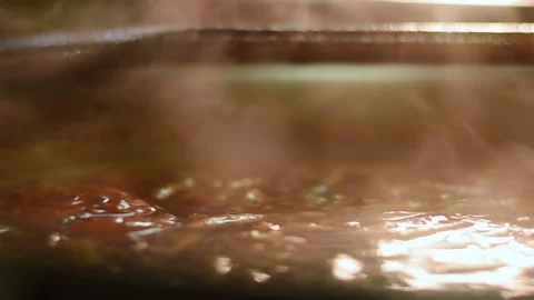 Close-up shot of hot boiling soup being stirred, steaming Video stock 105668013