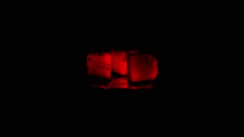 Close-up shot of hot coals in complete darkness. Stock Footage 147886560
