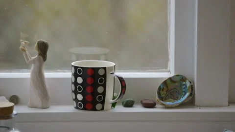 Close-up shot of hot drink steaming on a window sill. Stock Footage 137980225