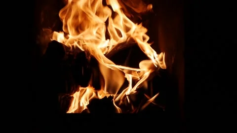 Close-up shot of hot fireplace full of dry firewood, warm cozy burning fire in a Stock Footage 137498700