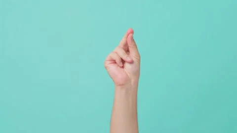 Close up shot of human hand, with finger snapping gesture in isolate blue screen Stock Footage 164938675