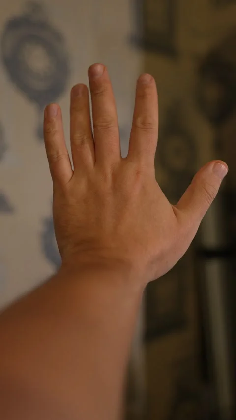A close-up shot of a human hand held out with the palm Stock Footage 328650892