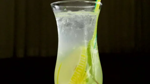 Close-up shot of ice being thrown into a glass of lemonade. Slow motion. HD 動画素材 107558820