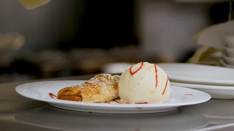 Close up shot of an ice cream and strudel dessert on the white plate 107343294
