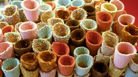 Close-up shot of ice cream cones sprinkled with colorful candy. 4K Video stock 124647771