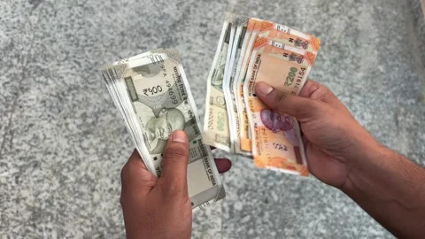 Close up shot of an Indian man counting currency cash outdoors Stock Footage 339216332
