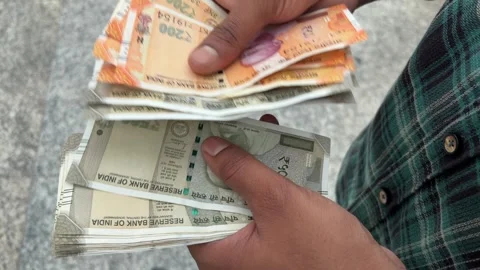 Close up shot of an Indian man counting currency cash outdoors Stock Footage 339216552